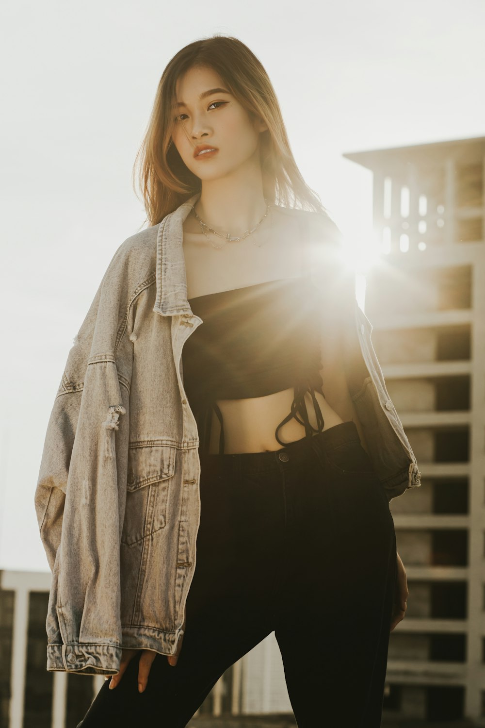 a woman in black pants and a jean jacket