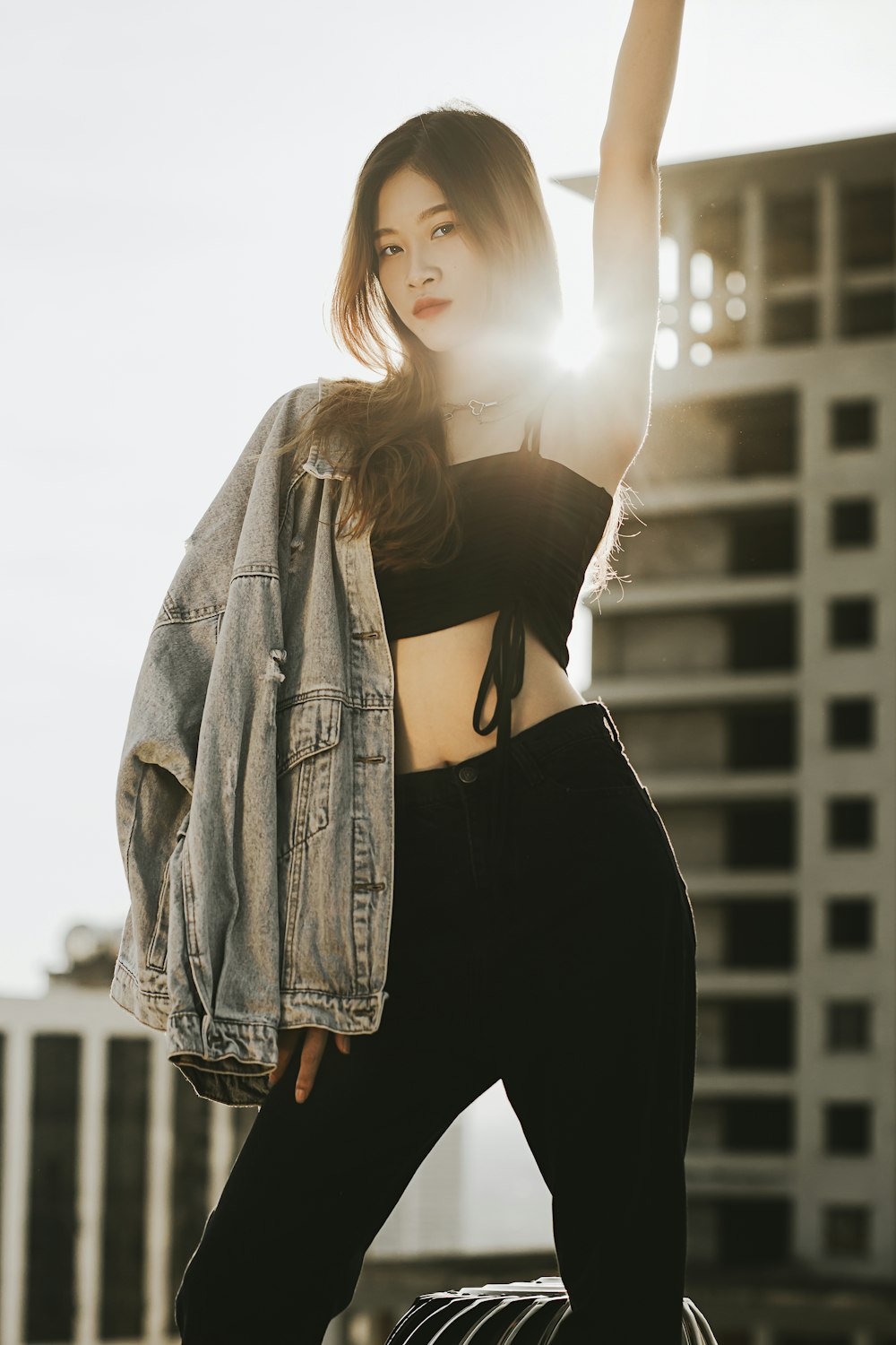 a woman in a crop top and black pants