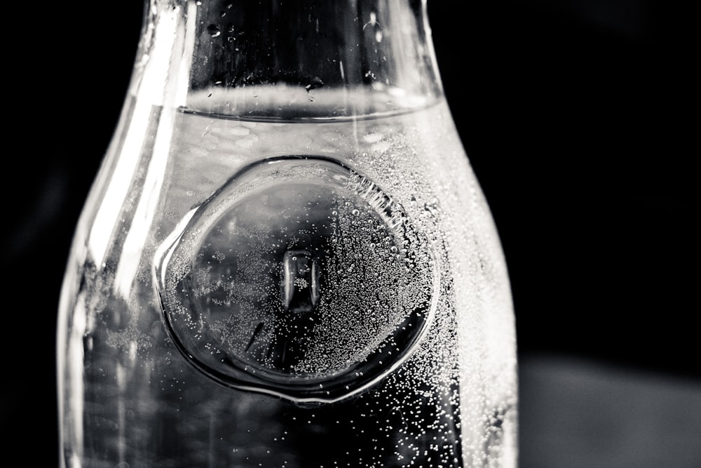 a close up of a bottle of water with bubbles