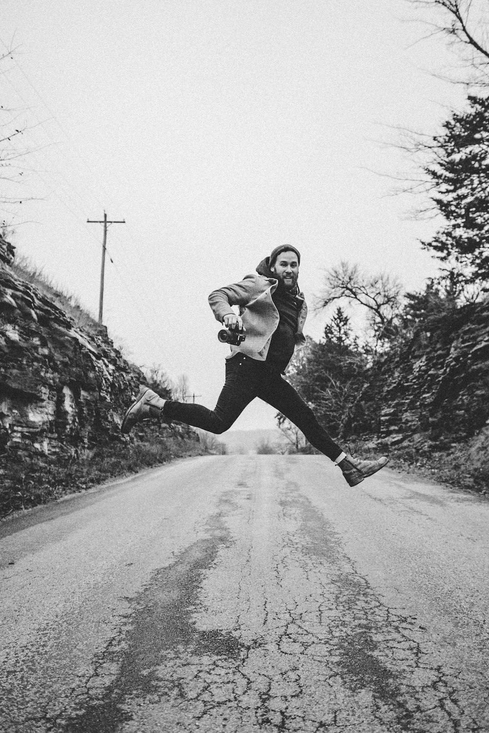 a person jumping in the air on a road