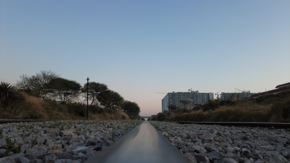 a view of a train track with buildings in the background