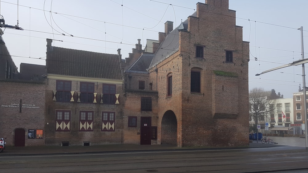 a train traveling past a tall brick building