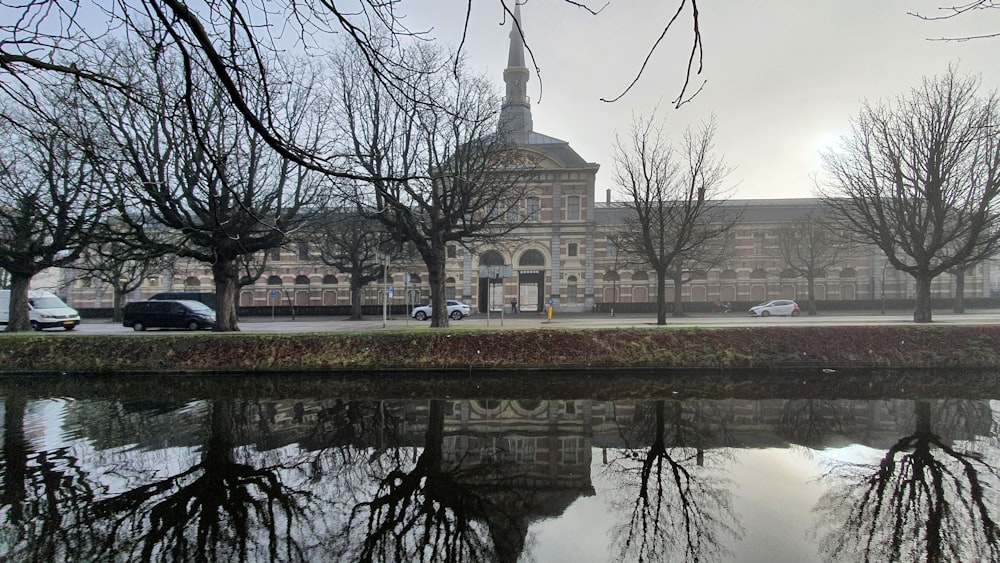 a large building with a tower next to a body of water