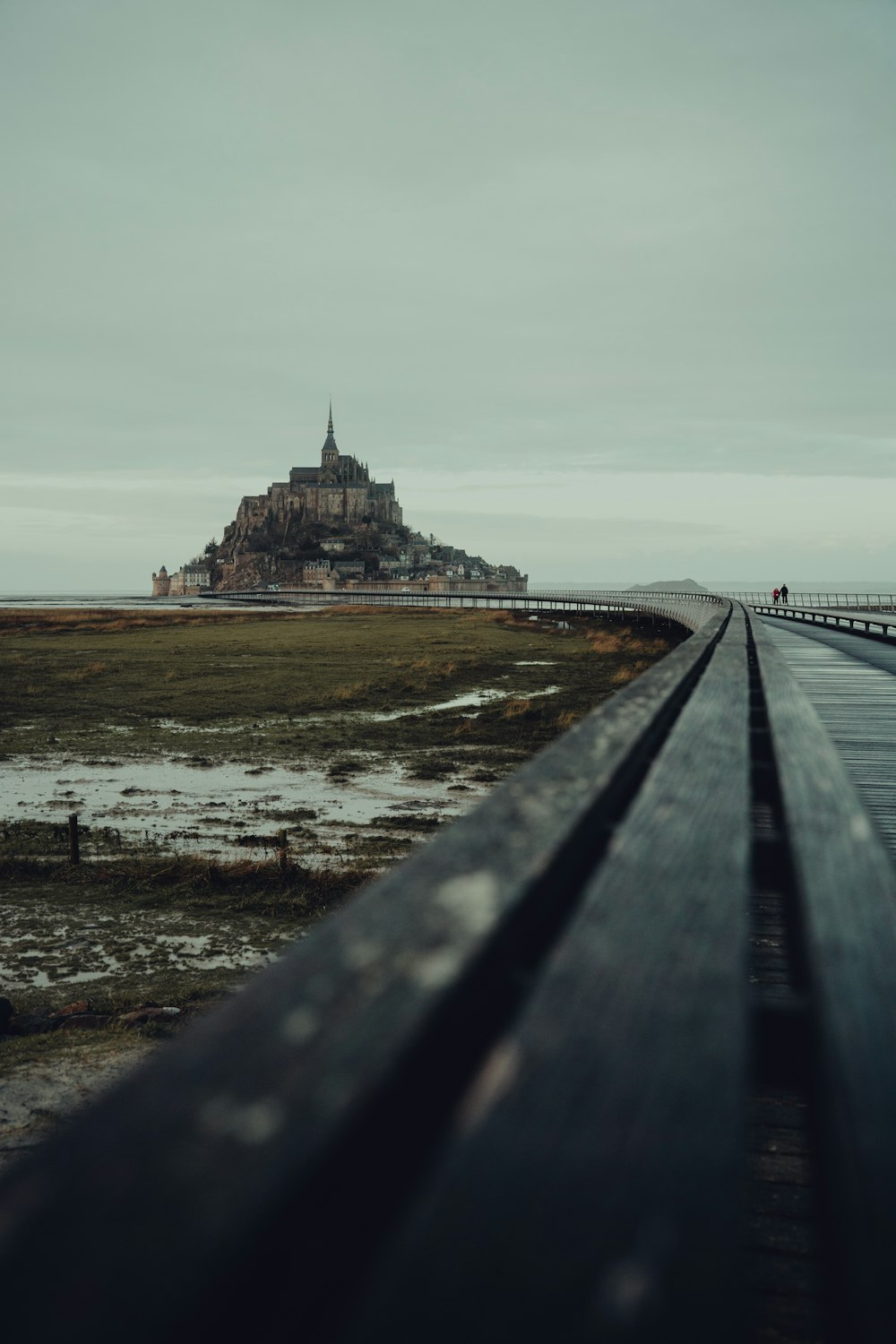 a long road with a small island in the background