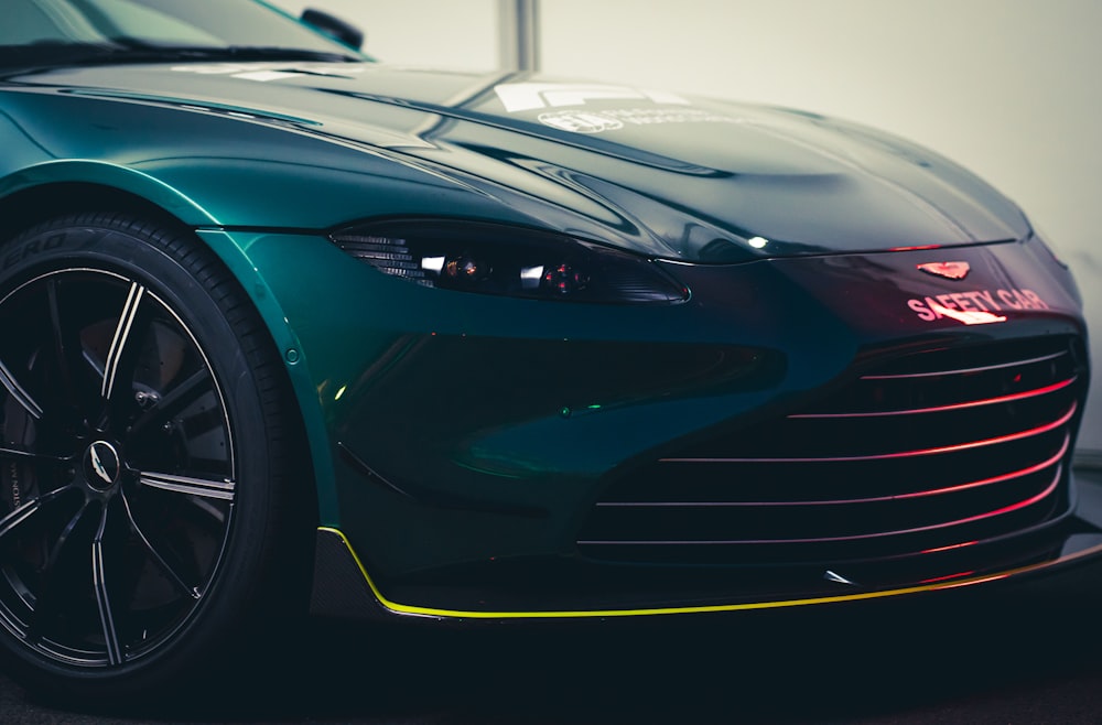 a green sports car parked in a garage