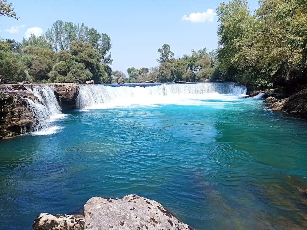 a river with a waterfall in the middle of it