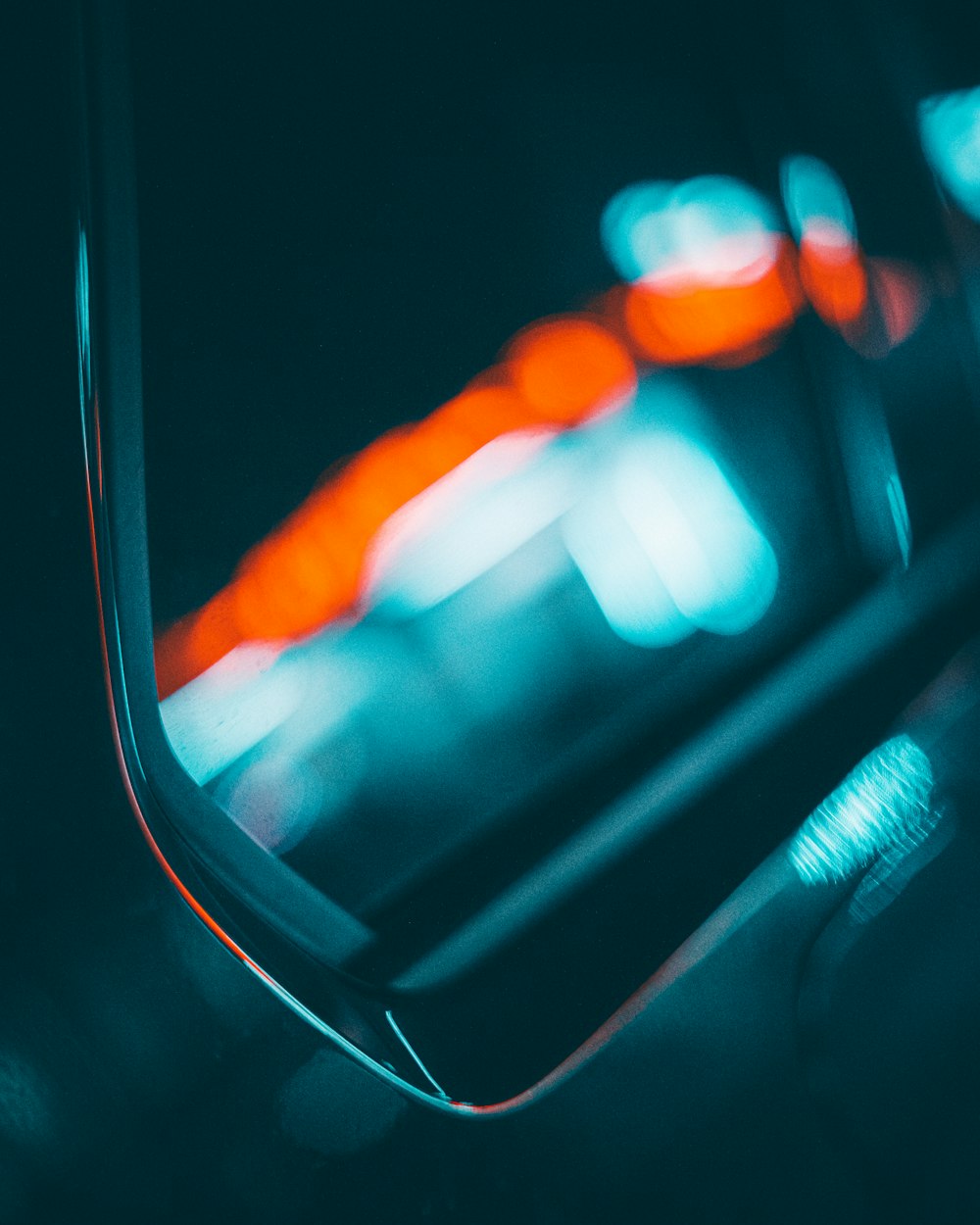 a close up of a car mirror with blurry lights in the background