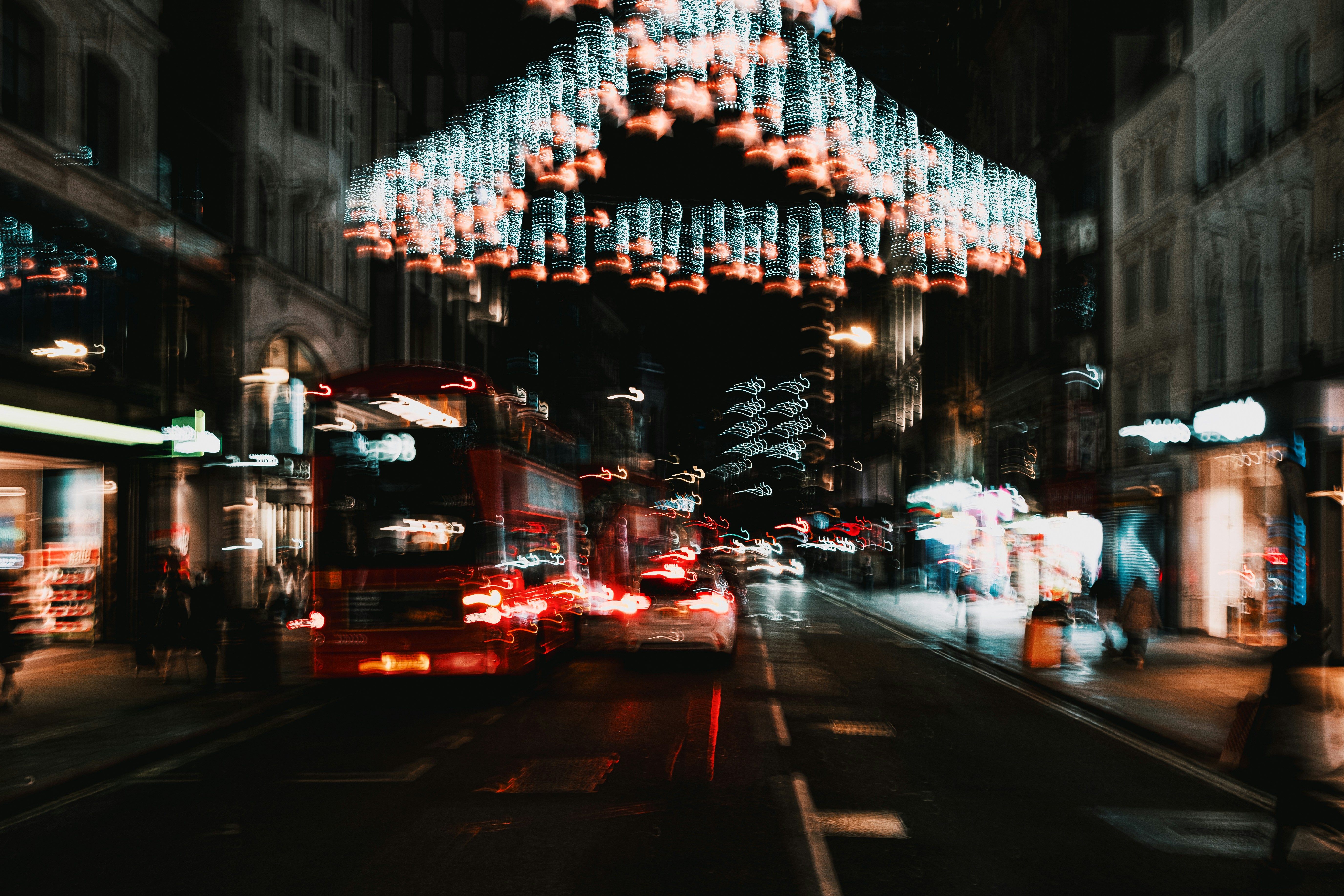 A person stands in sharp focus against a background of blurry, abstract city lights at night, representing a clear signal amidst digital noise.