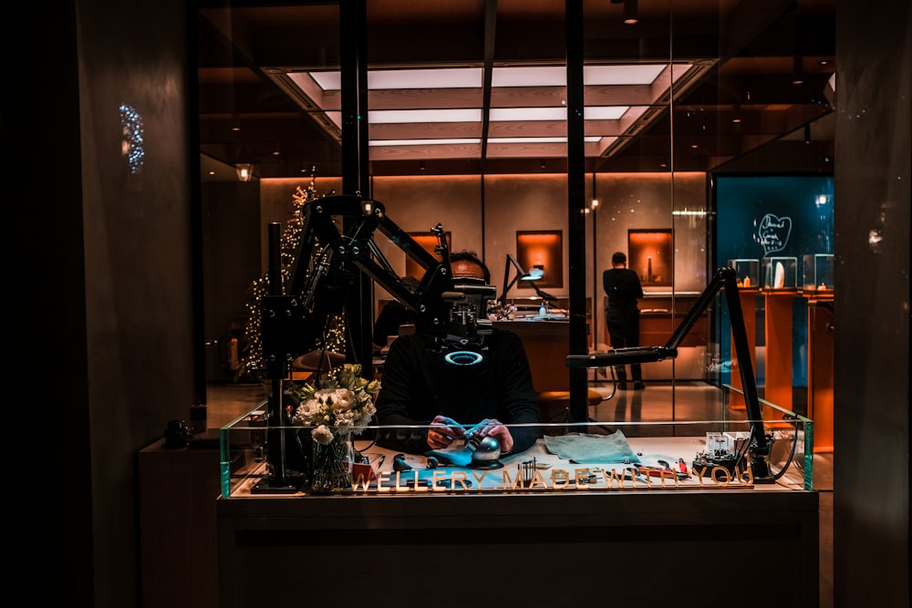 a man sitting in front of a display case