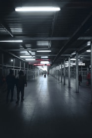 a group of people walking down a long hallway