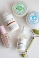 a white table topped with three different types of skin care products
