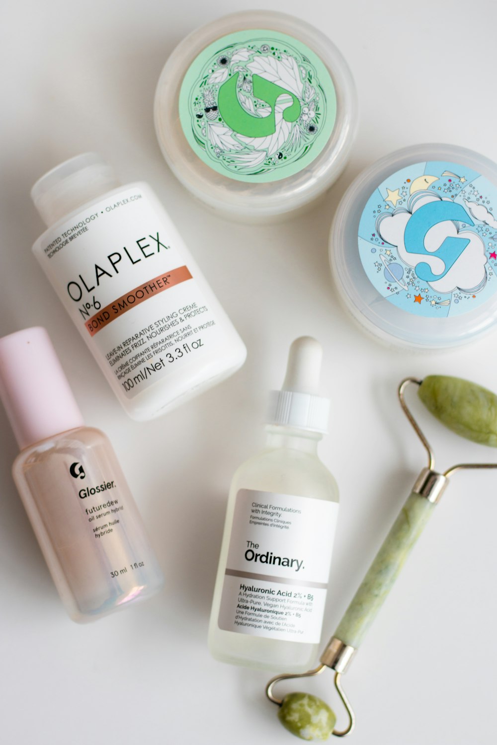 a white table topped with three different types of skin care products