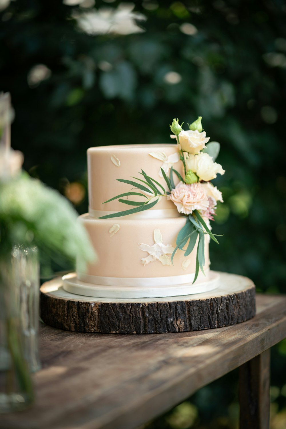 a wedding cake sitting on top of a wooden table