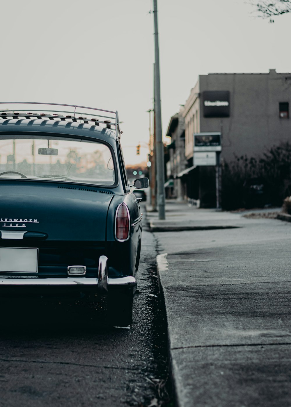 an old car parked on the side of the road