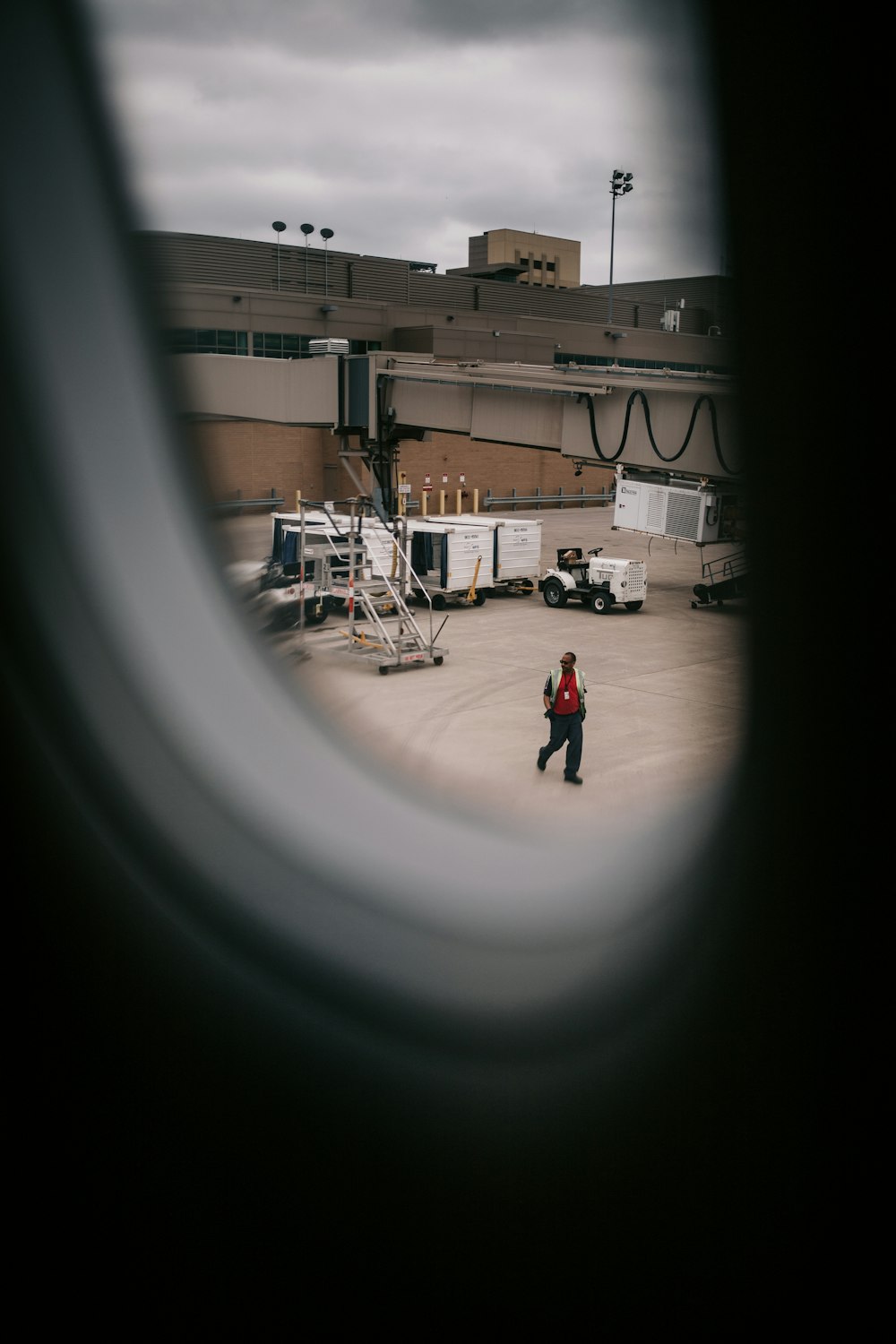 a man walking across an airport tarmac