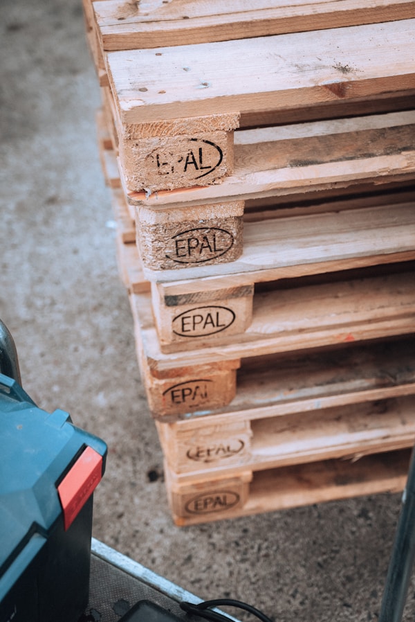 a pile of wooden pallets sitting on top of a floorby Chris Kursikowski