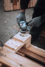 a person using a grinder on a piece of wood