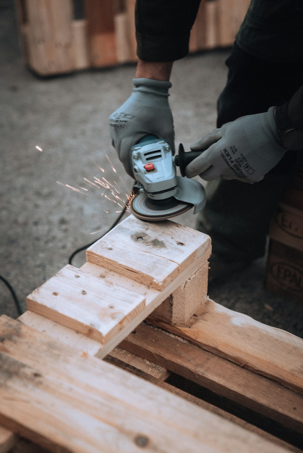 a person using a grinder on a piece of wood