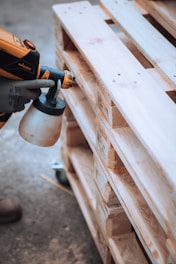 a person using a drill gun on a piece of wood