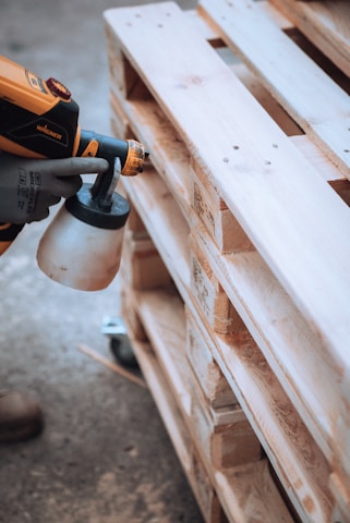 a person using a drill gun on a piece of wood