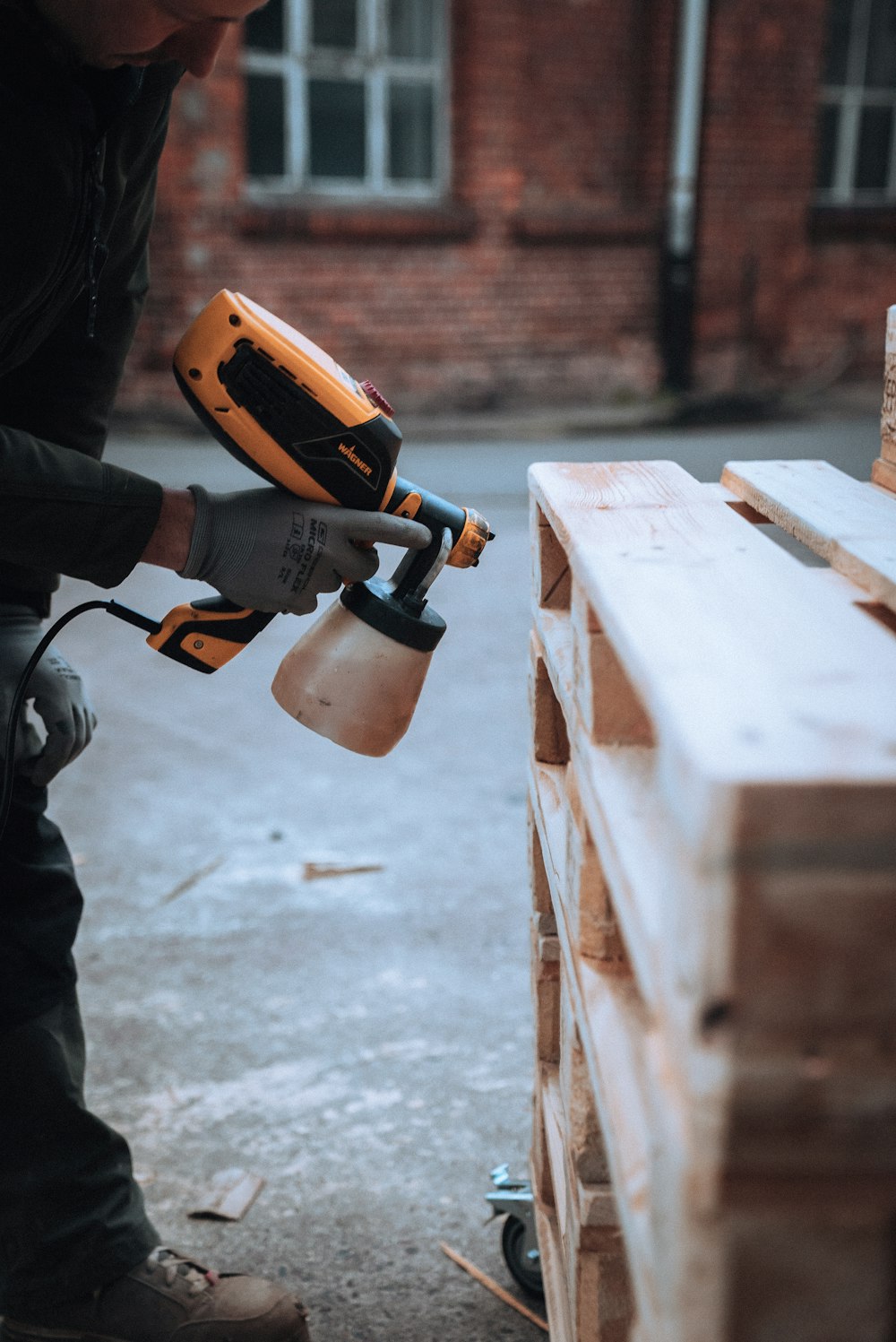 a man using a drill gun on a piece of wood