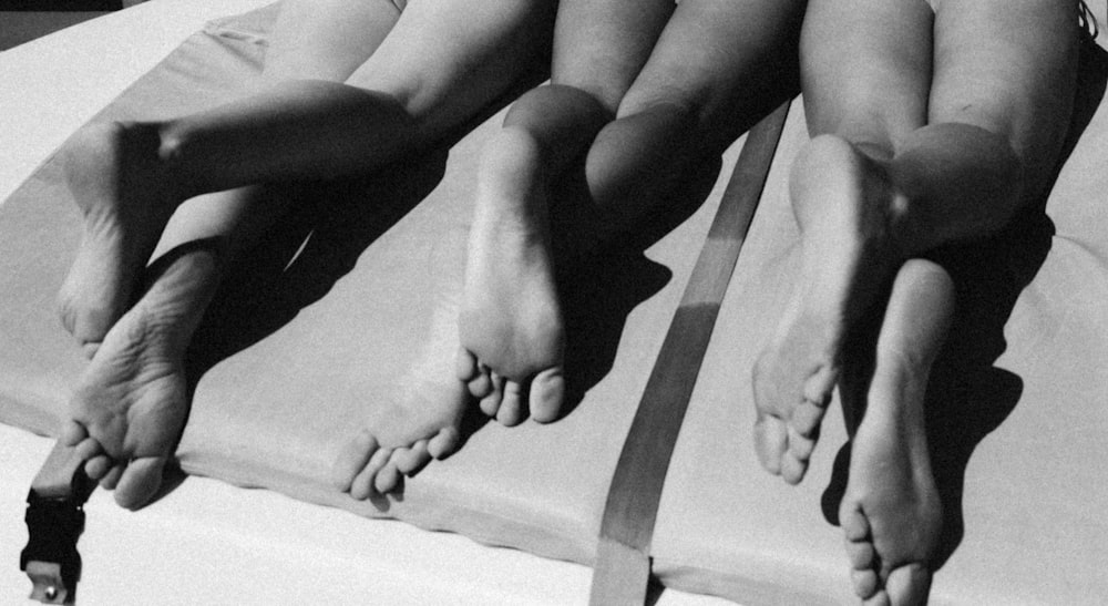 a black and white photo of a person laying on a bed