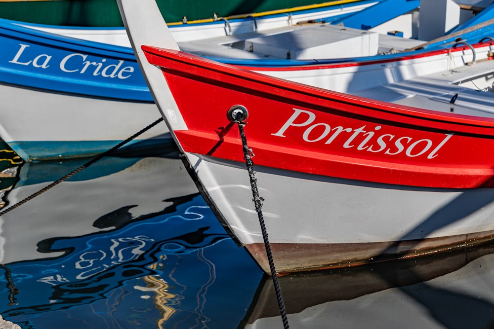 a row of boats sitting next to each other on a body of water