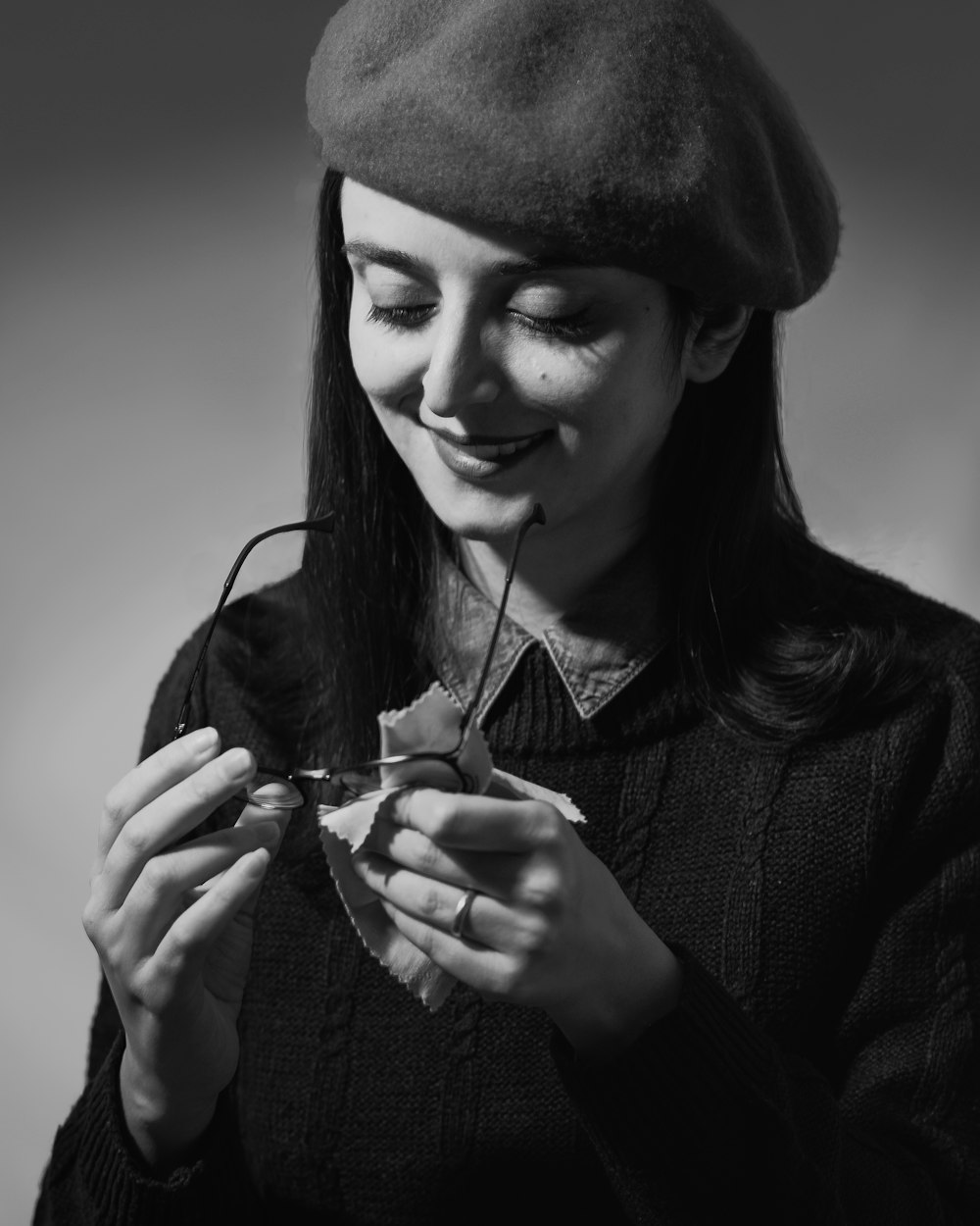 a woman wearing a hat and holding something in her hands