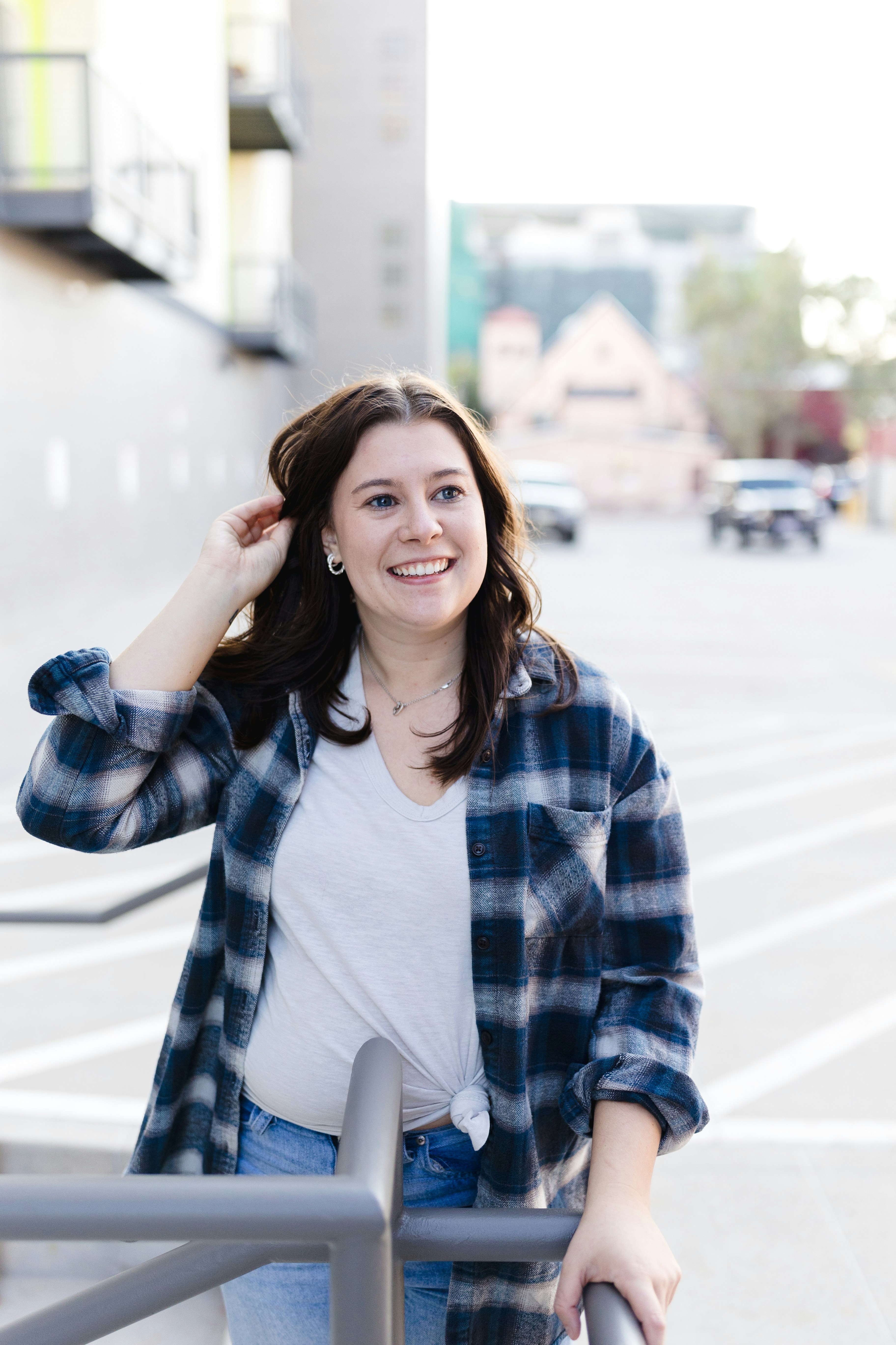 A woman standing next to a metal railing photo – Free Person Image on ...