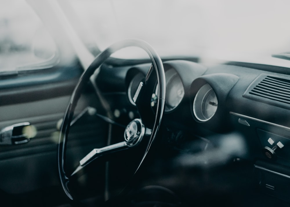 a car dashboard with a steering wheel and a dash board