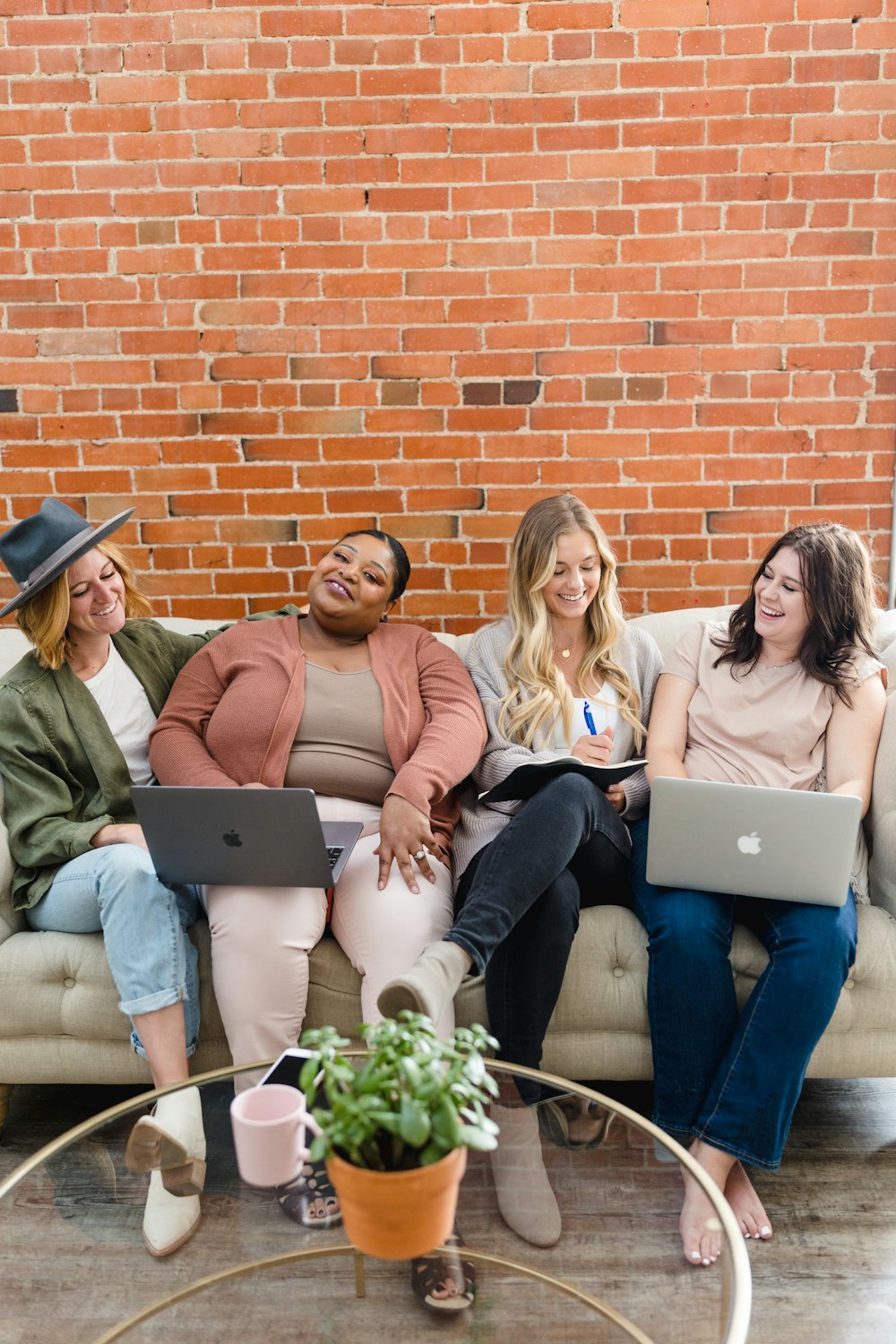 a group of women sitting on top of a couch