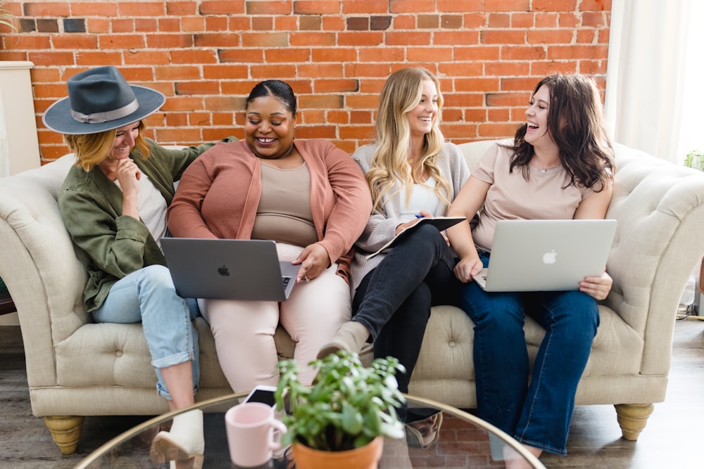 a group of women sitting on top of a couch