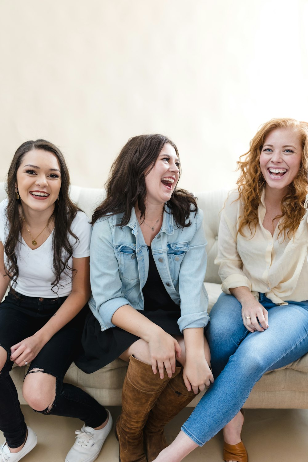 a group of women sitting on top of a couch
