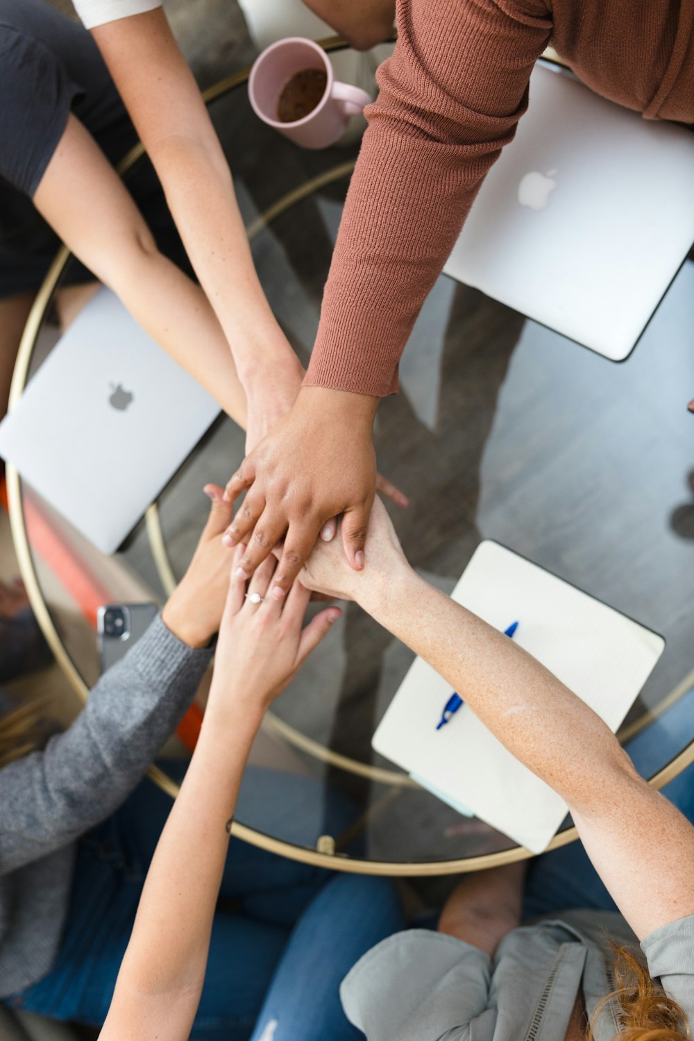 a group of people putting their hands together