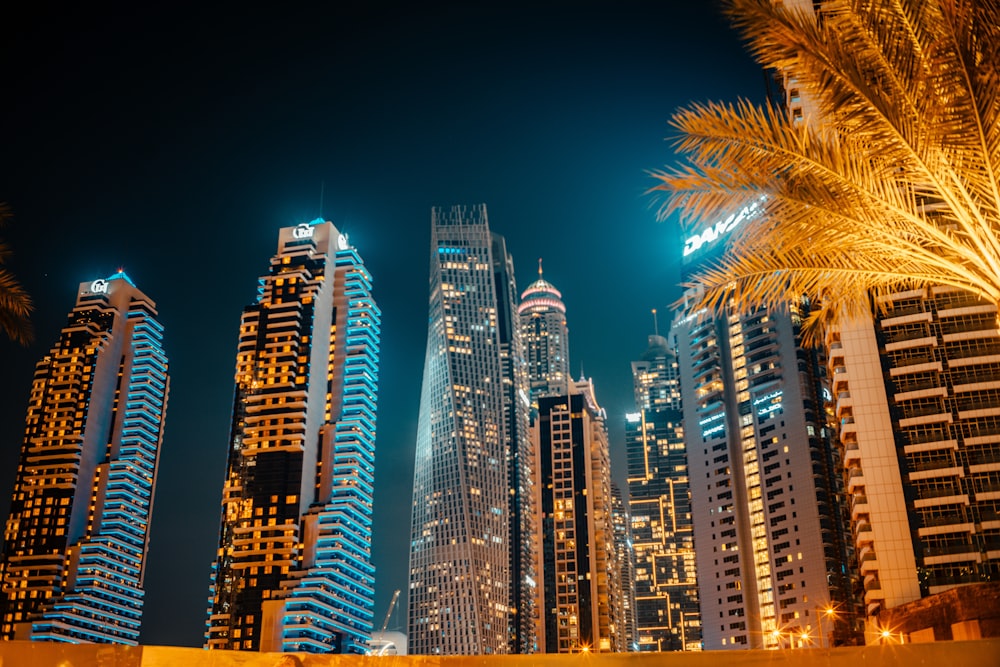 a group of tall buildings in a city at night