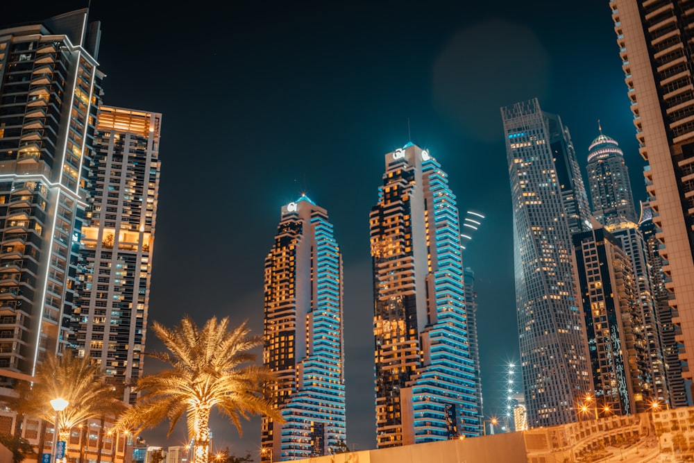 a group of tall buildings in a city at night