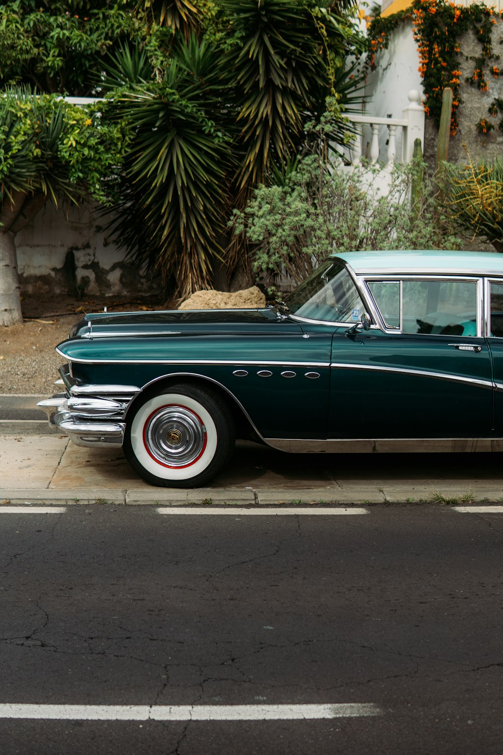 a green car parked on the side of the road