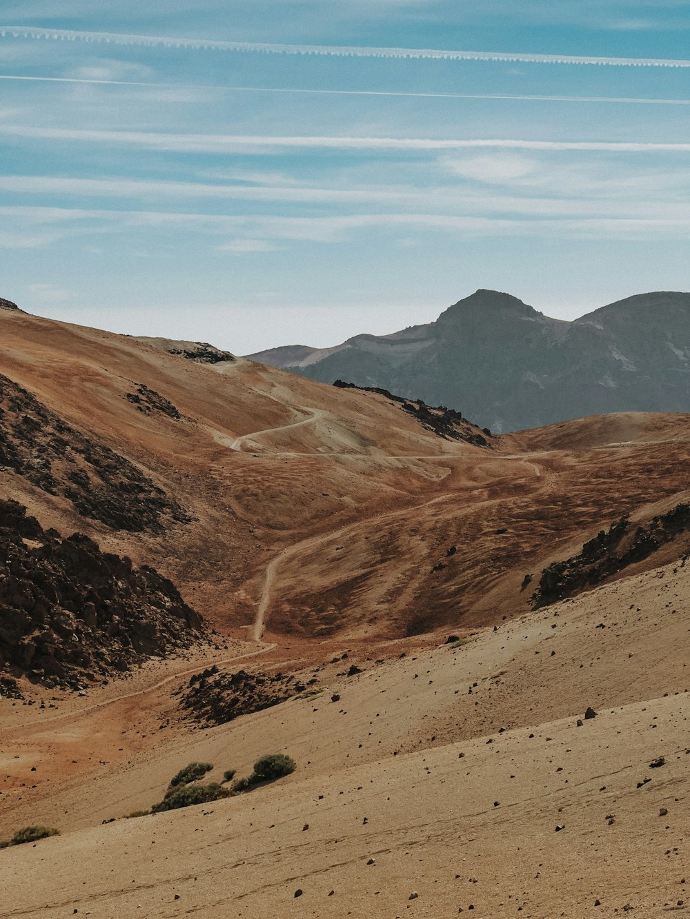 a view of a mountain range with hills in the background