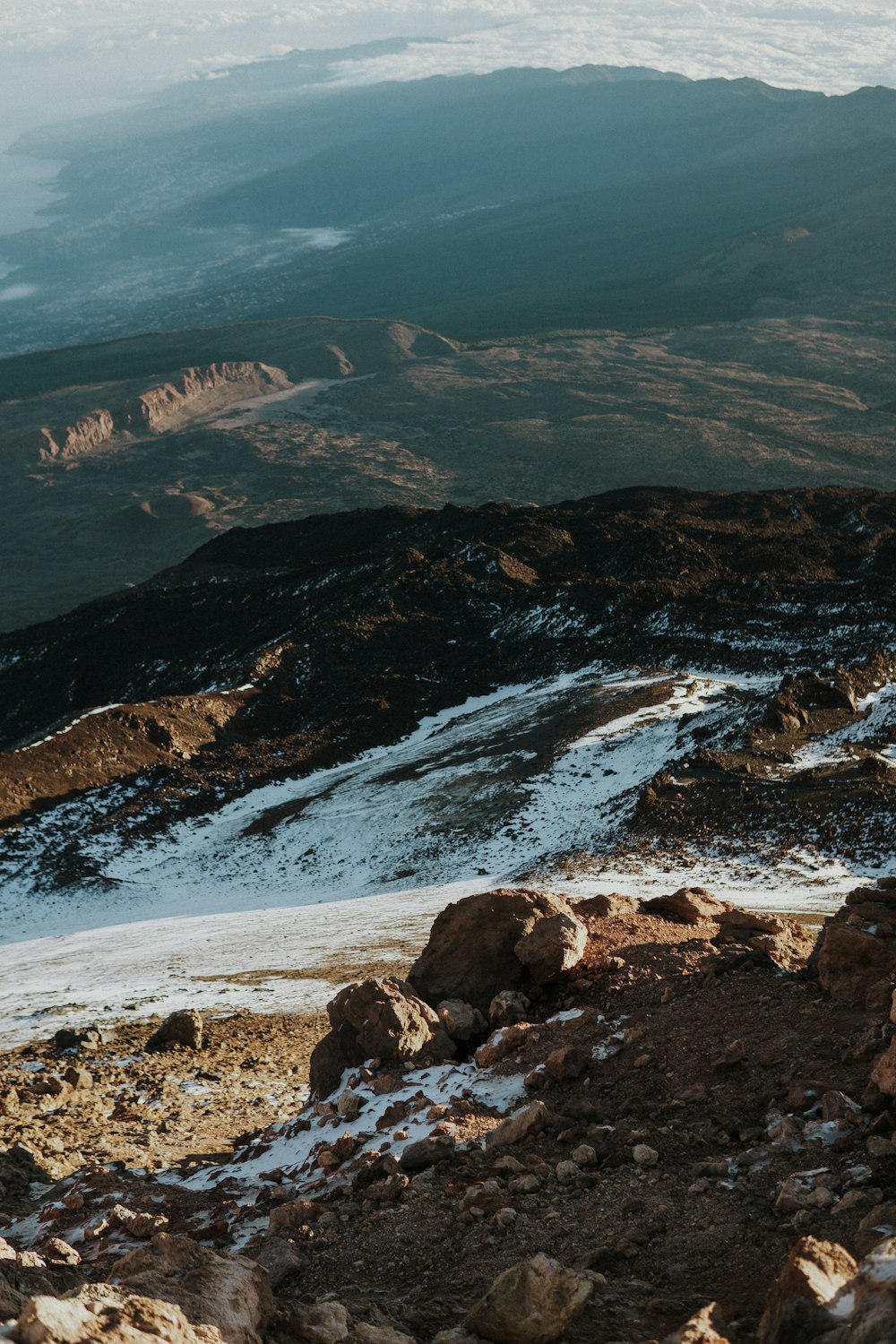 a man standing on top of a snow covered mountain