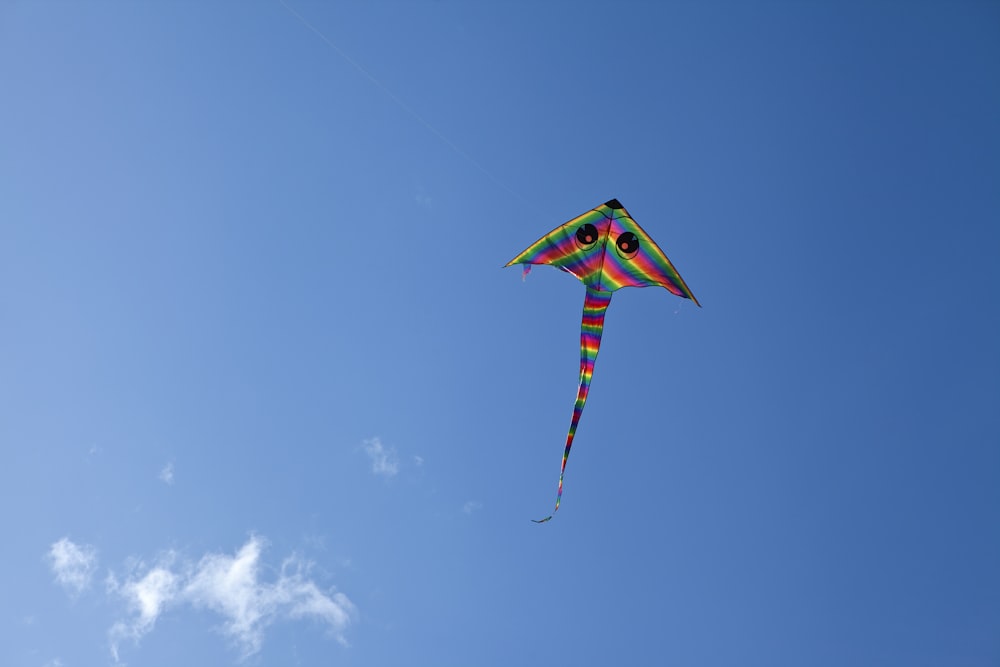 a colorful kite flying in a blue sky