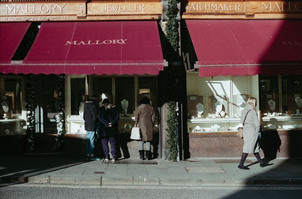 a group of people standing outside of a store