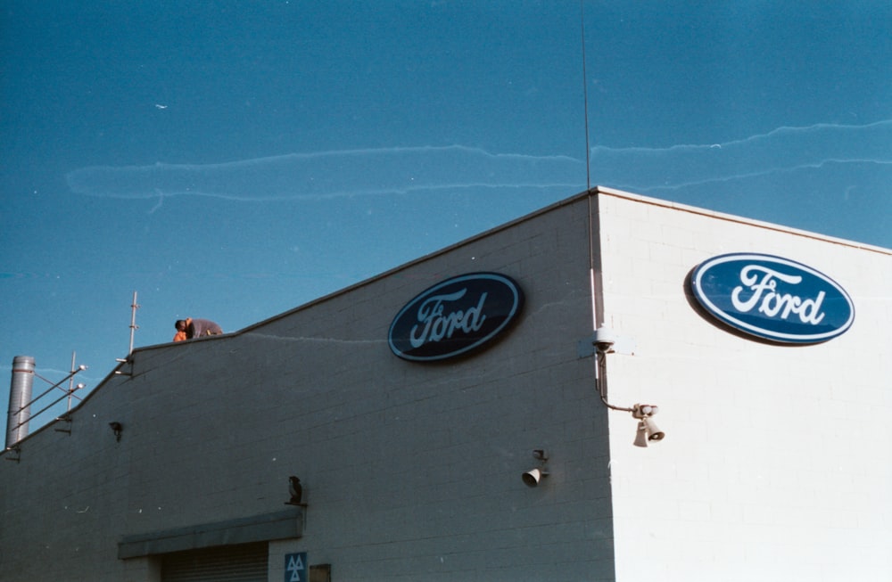 a ford dealership with a blue sky in the background
