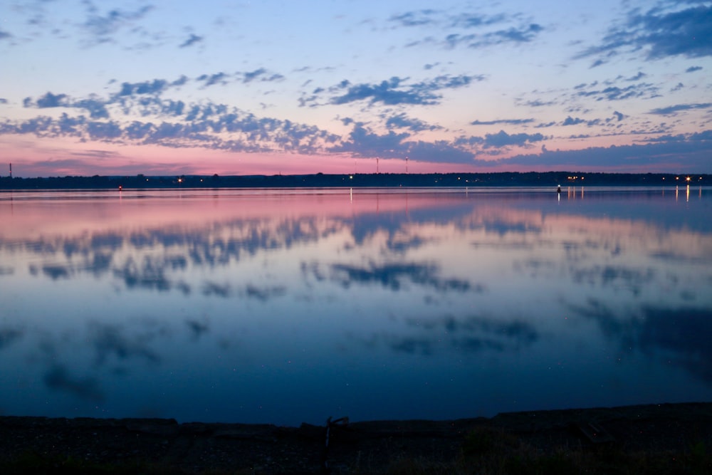 a large body of water with clouds in the sky