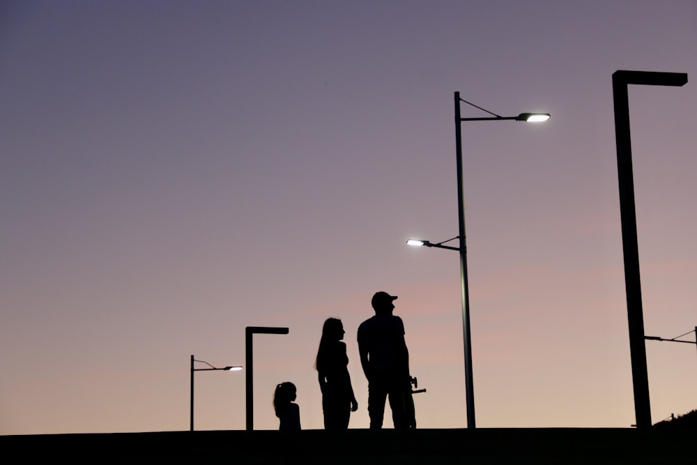 a man and a woman are standing under street lights