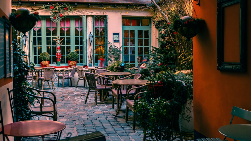 a courtyard with tables and chairs and potted plants