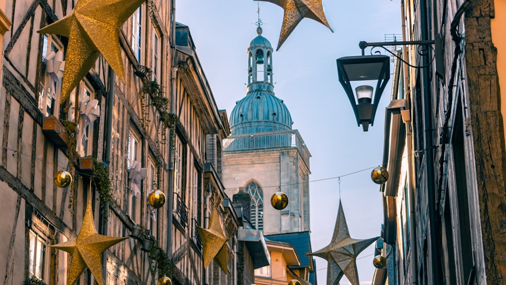 a city street lined with tall buildings and christmas decorations