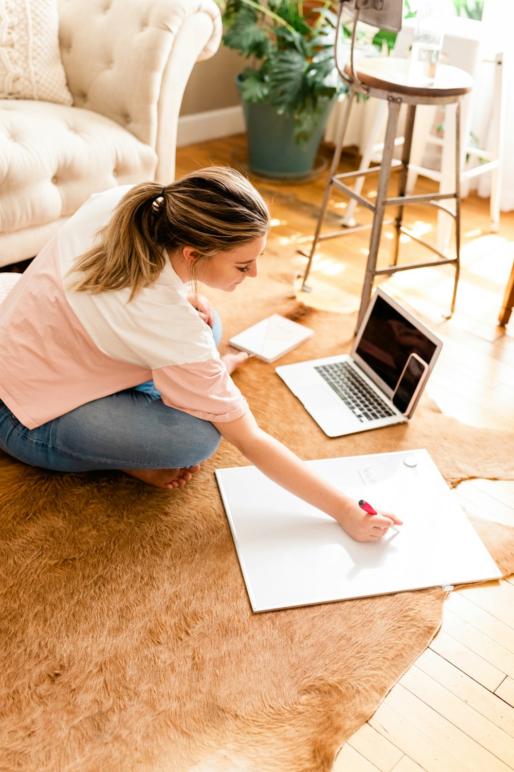 a person sitting at a table using a laptop