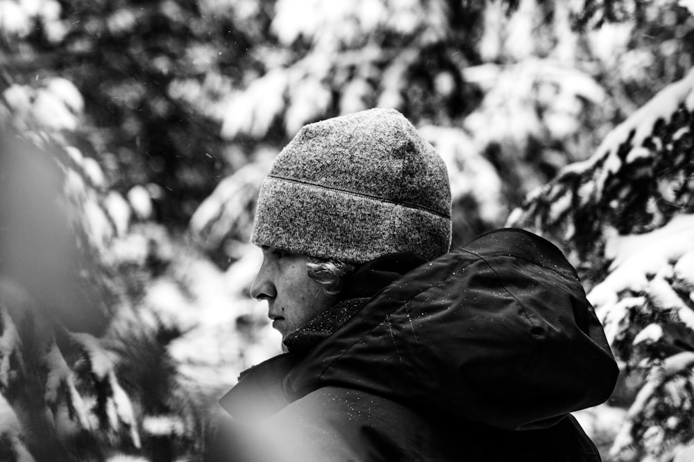 a black and white photo of a man in the snow