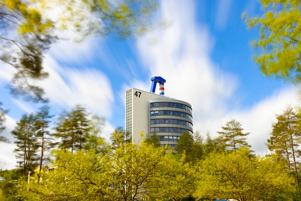 a tall building sitting in the middle of a forest