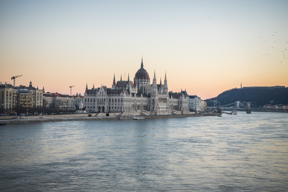 a view of a large building on the side of a river